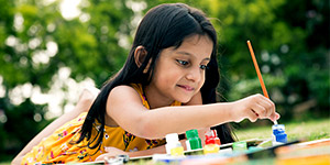 Child Painting in Park