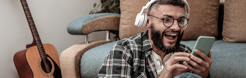 Man listening to music on mobile device