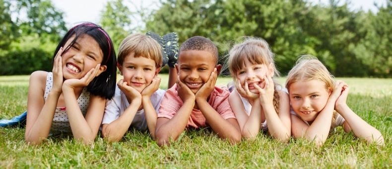 Group of kids laying in grass