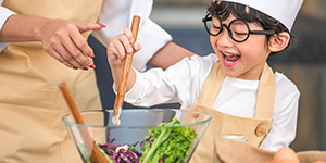 Young Boy Making Salad