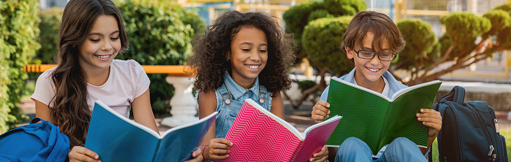 Kids reading outdoors