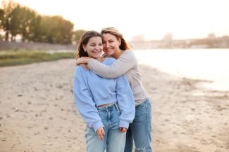 teen girl with mom on beach