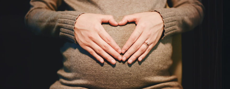 Pregnant mom with hands on belly